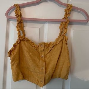 Yellow crop top with buttons and ruching on the straps!
